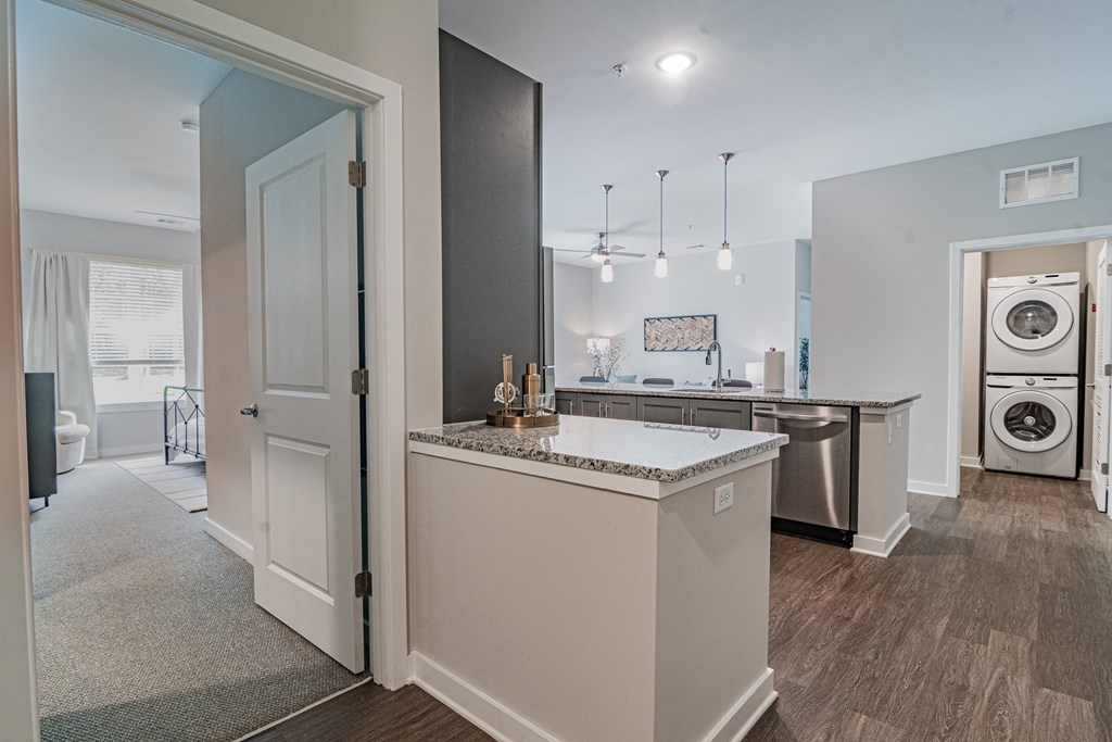 an open kitchen and laundry room with a washer and dryer