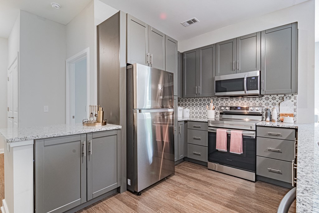 a kitchen with stainless steel appliances and granite counter tops
