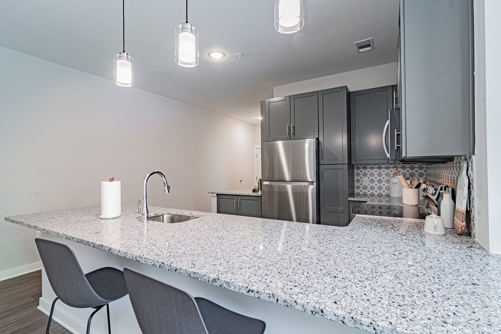 a kitchen with a granite counter top and stainless steel appliances