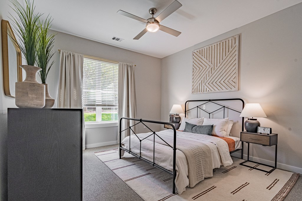 a bedroom with a bed and a ceiling fan