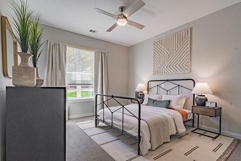 a bedroom with a bed and a ceiling fan