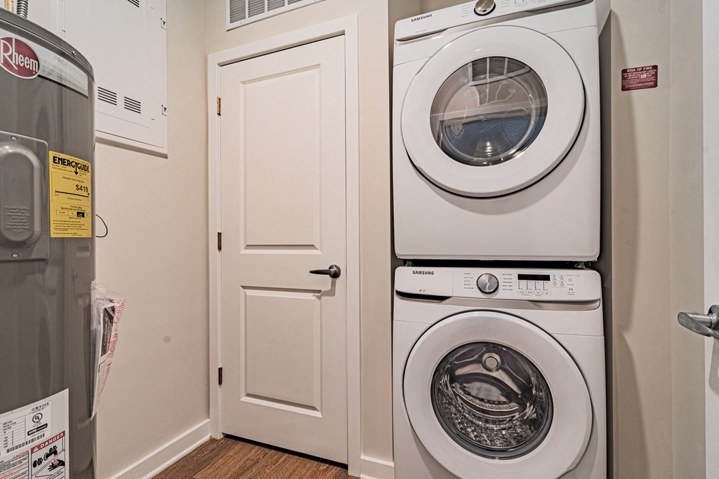 a front loading washer and dryer combo in a laundry room