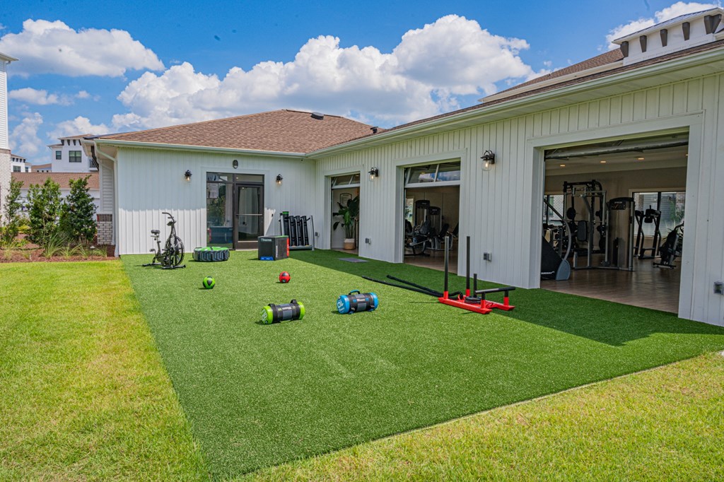 a home gym with weights and equipment on the lawn