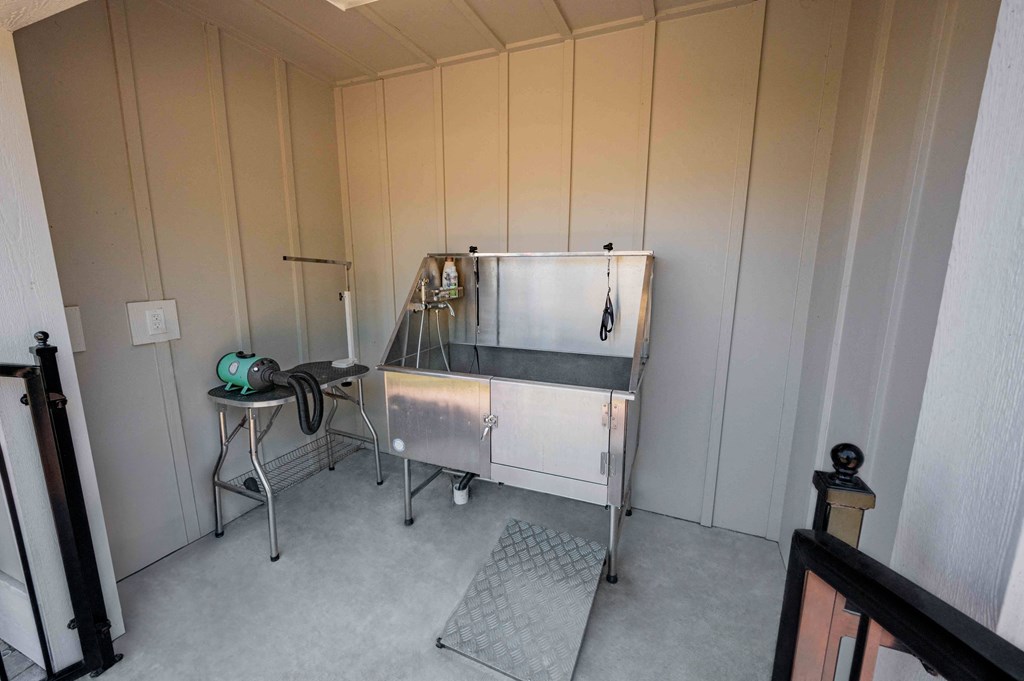 a small room with a sink and a refrigerator