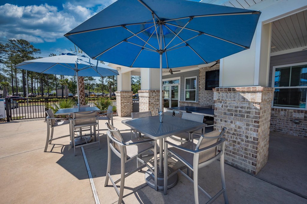 a covered patio with tables and umbrellas