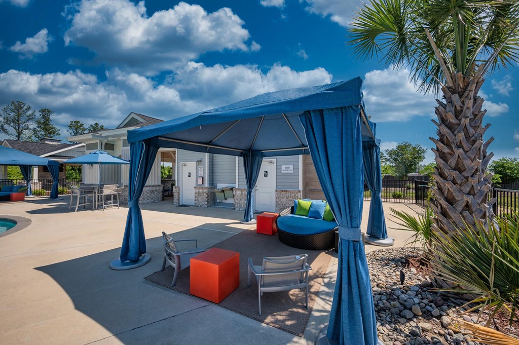 our apartments have a patio with a canopy and chairs