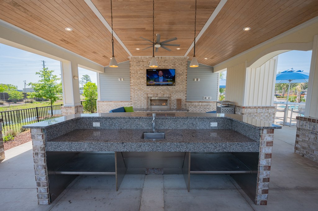 a large kitchen with a sink and a fireplace