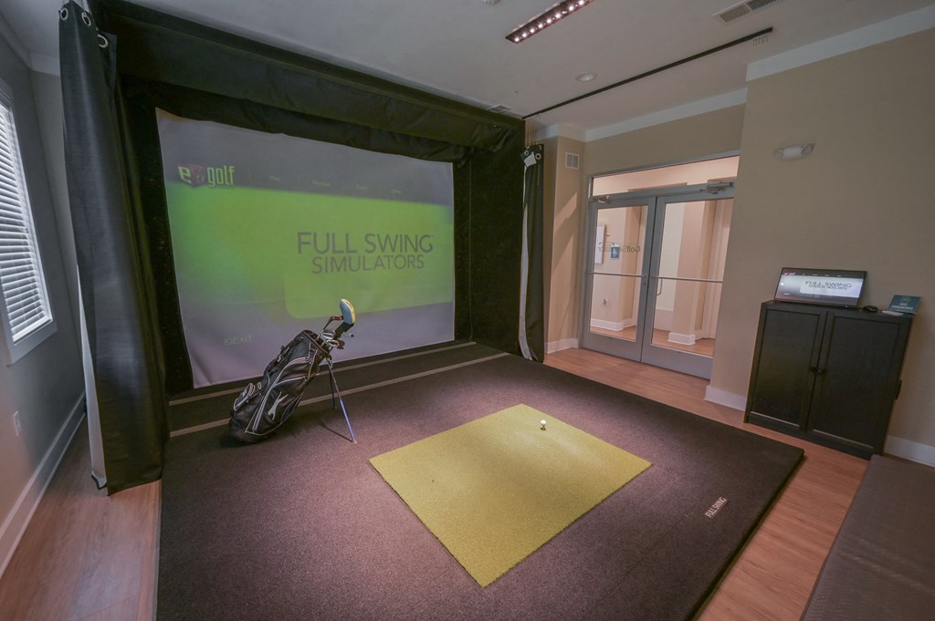 a room with a projector screen and a microphone on the floor