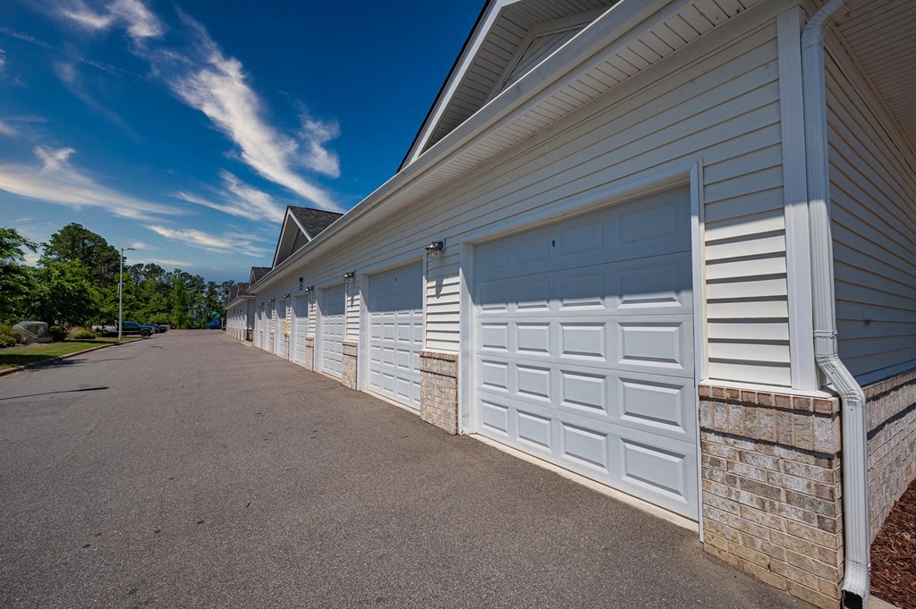 white garage doors on the side of a building
