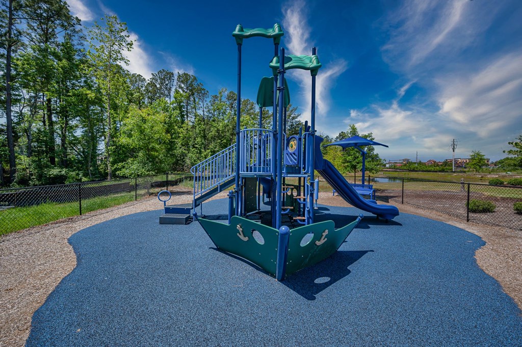 a playground at a park with a swing set