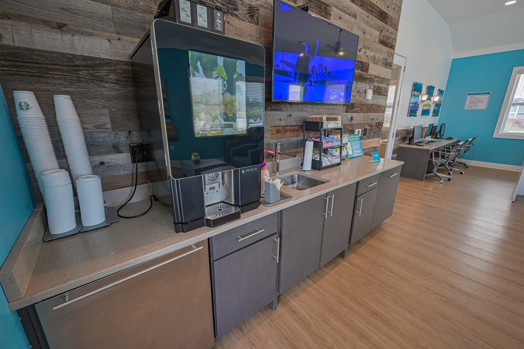 the lobby of a coffee shop with a counter and a tv