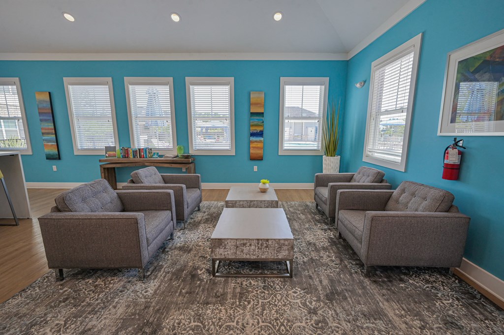 a living room with blue walls and couches and a coffee table