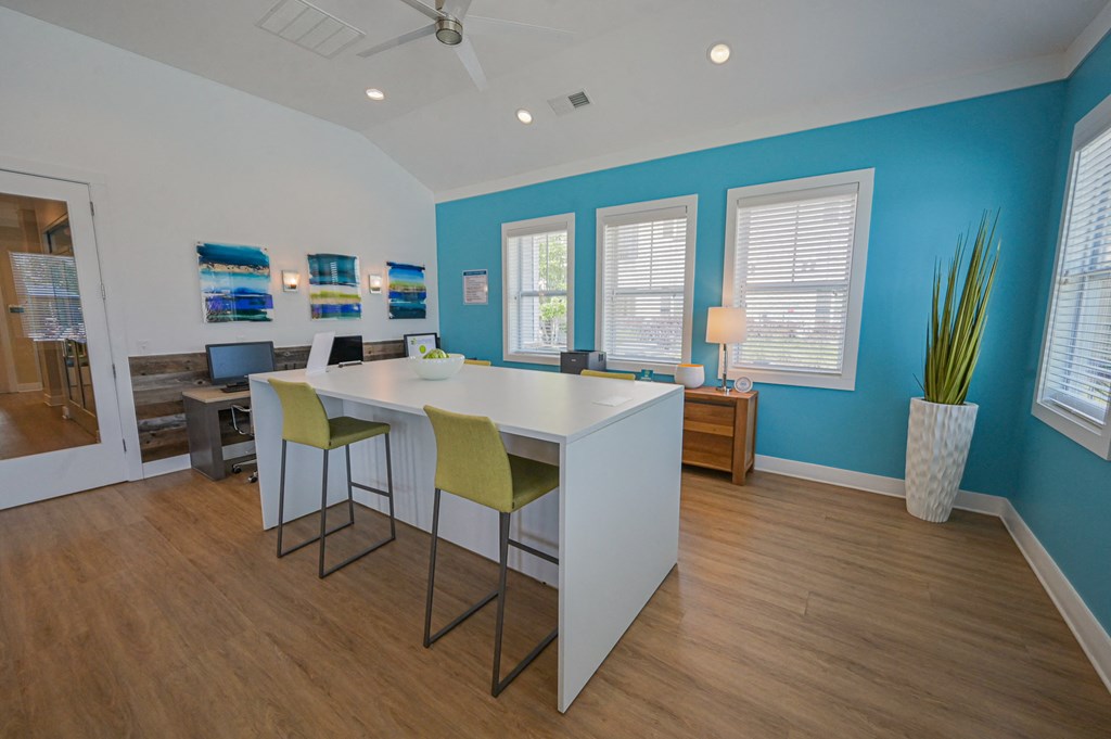 an office with a white table and chairs and a blue wall