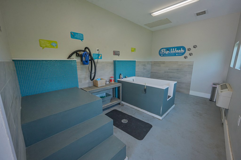 a bathroom with a tub and a staircase in a house
