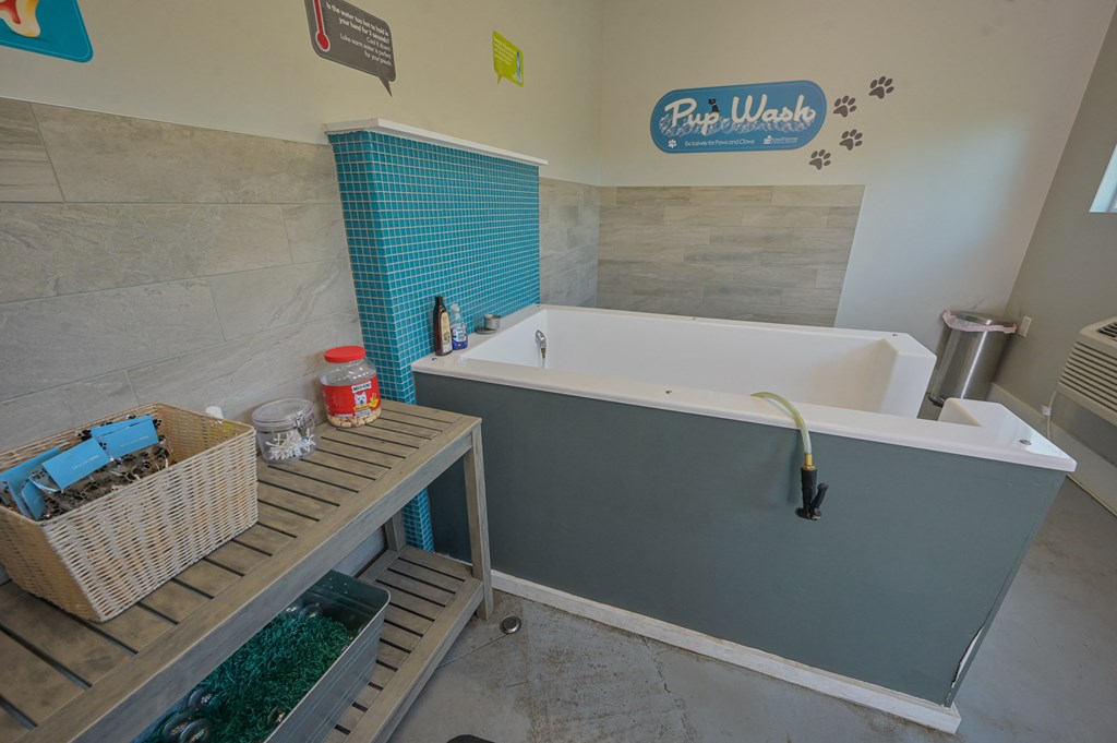 a bathroom with a bath tub and a sink and a table