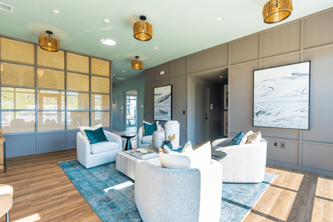 a living room with blue and white furniture and windows
