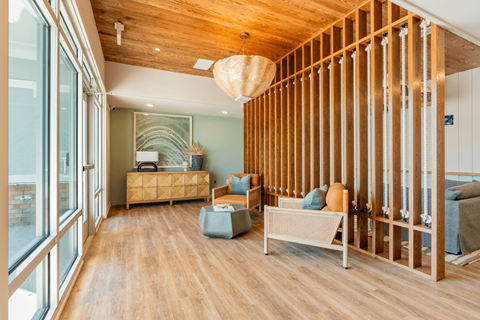 a living room with wood dividers and a couch