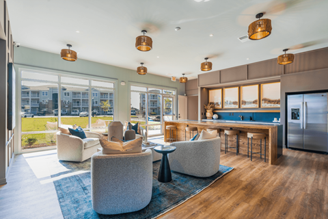 a living room with couches and chairs and a kitchen