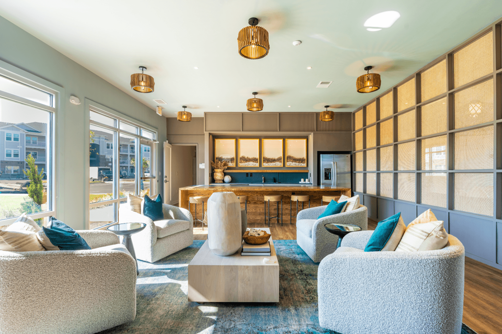 a living room with couches and chairs and a kitchen