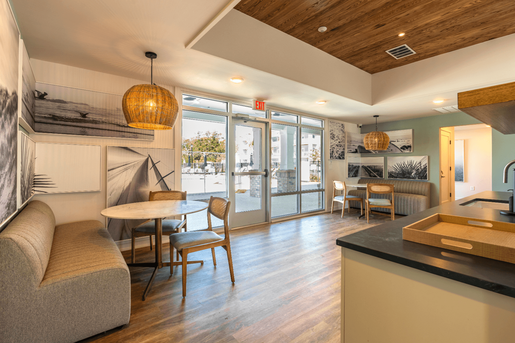 a living room with a table and chairs and a kitchen
