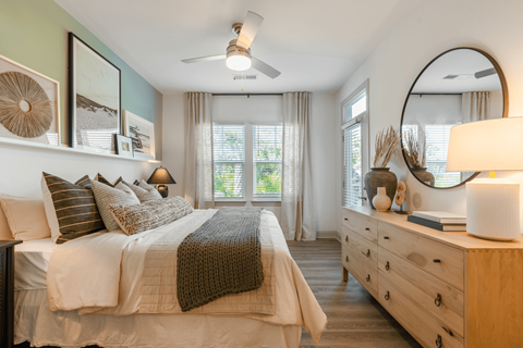 a bedroom with a bed and a mirror