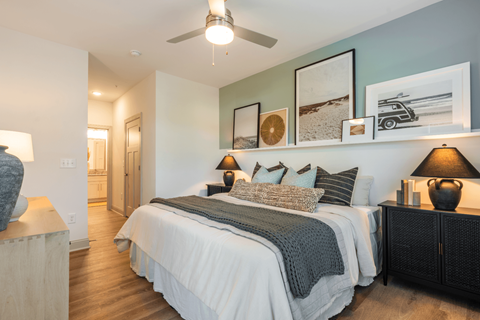 a bedroom with a bed and a ceiling fan