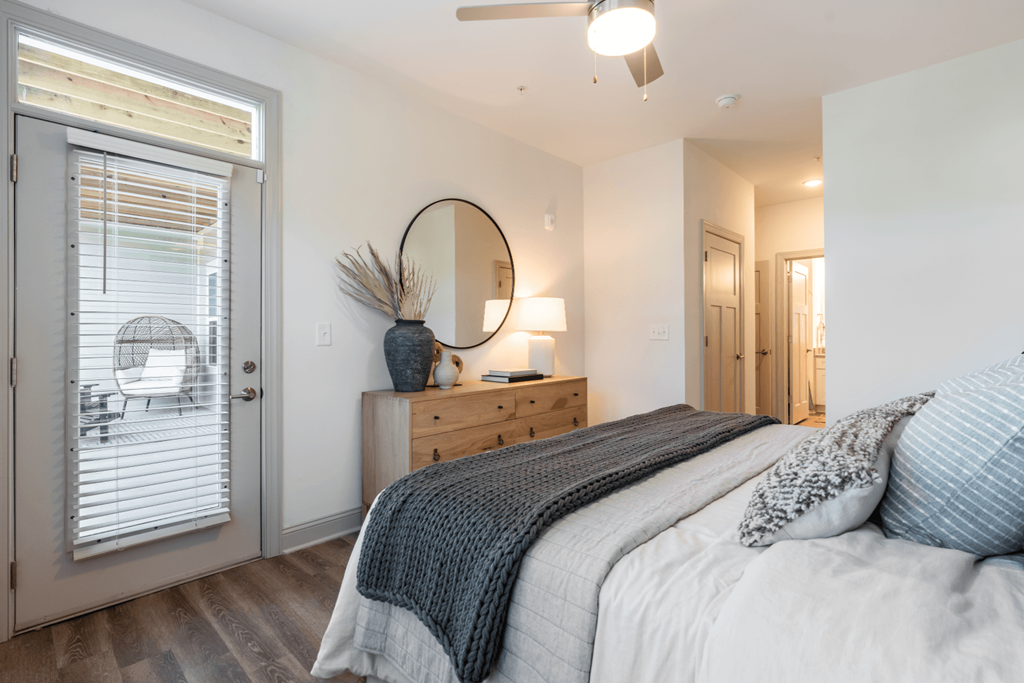 a bedroom with a bed and a door to a patio