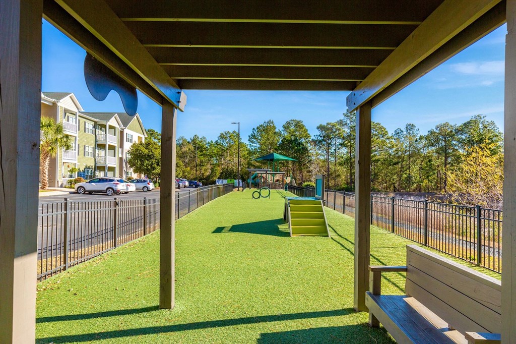 a view of a park with a playground and a bench
