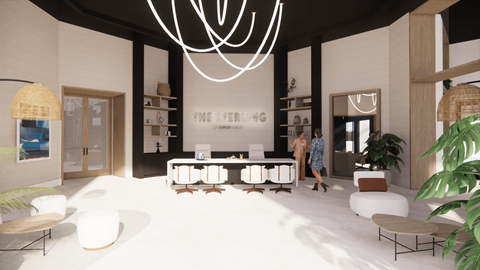 A modern living room with a large white sofa and a chandelier.