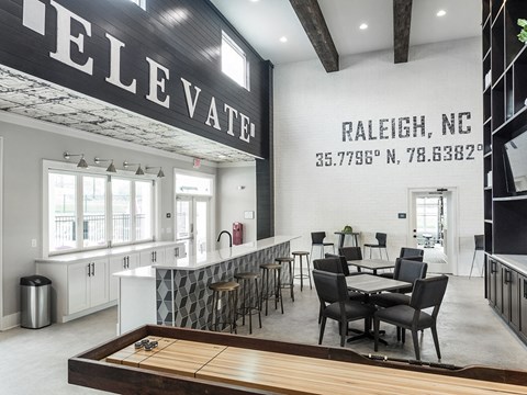 a dining room with a table and chairs in front of a counter