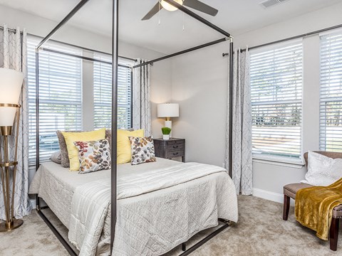 a bedroom with a bed and a ceiling fan