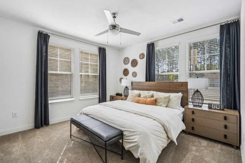 a bedroom with a bed and a ceiling fan