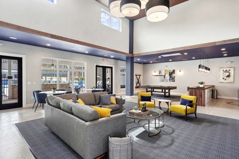 a living room filled with furniture and a large chandelier