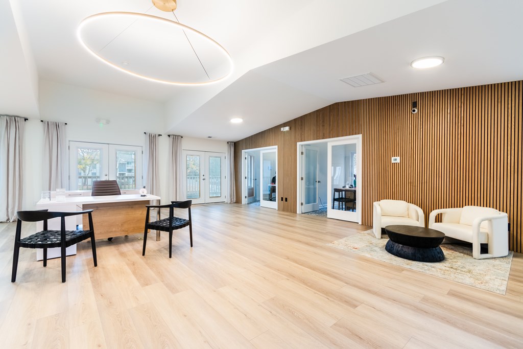 A modern living room with wooden floors and furniture.