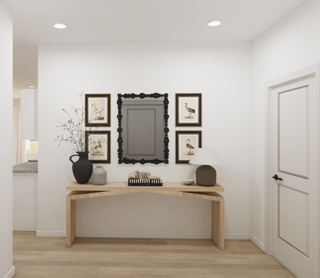 a hallway with a vanity with a mirror and pictures on the wall