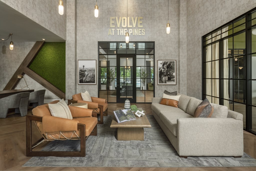 A modern living room with a green accent wall and a large window.