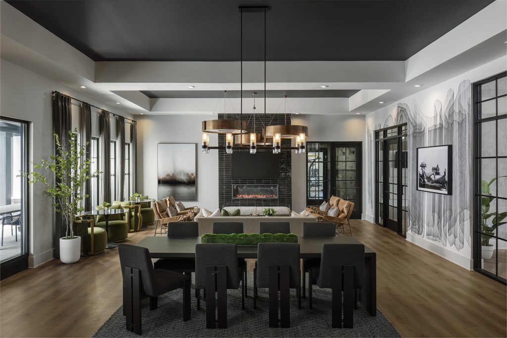 A modern dining room with a fireplace and a large table set for six.