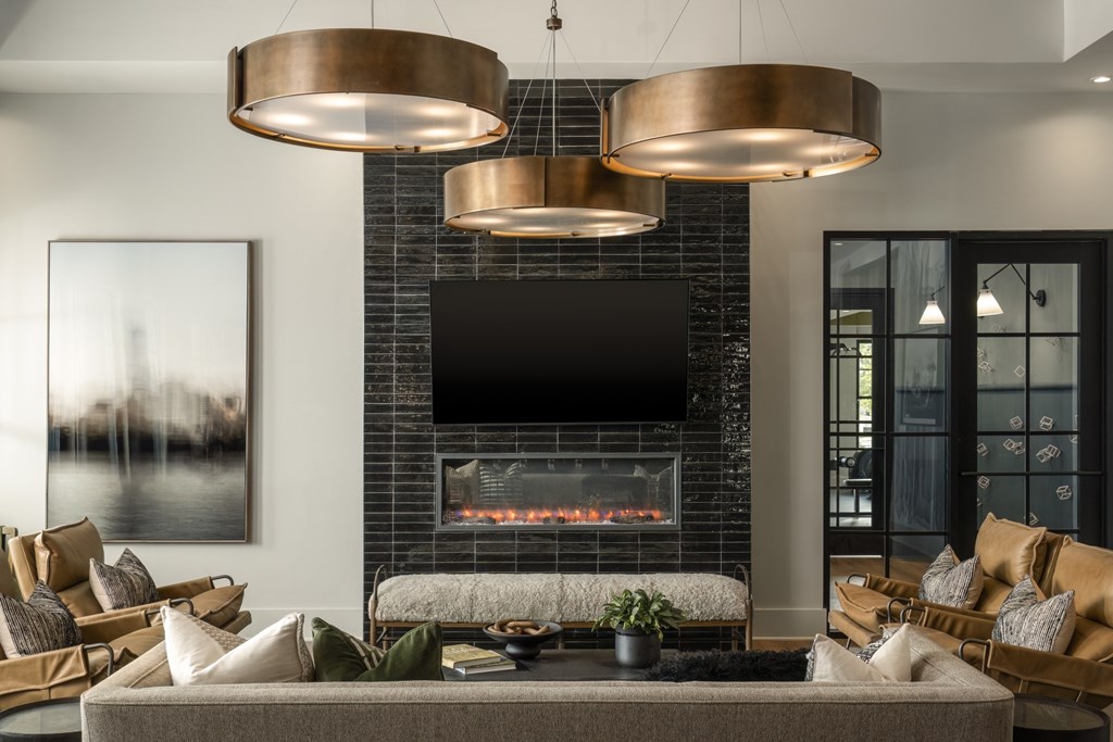 A modern living room with a fireplace and a television above it.