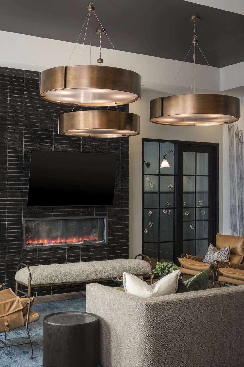 A modern living room with a fireplace and a grey sofa.