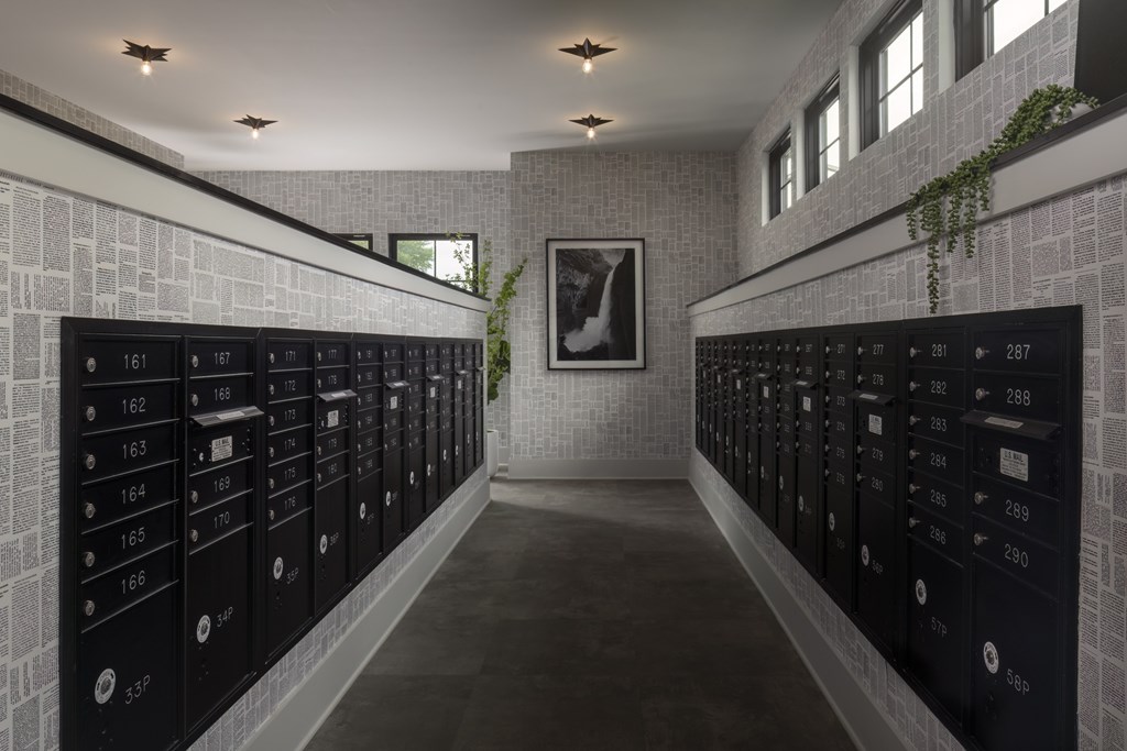 A hallway with a series of lockers on the wall.
