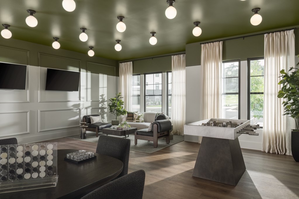 A modern living room with a large table and chairs.