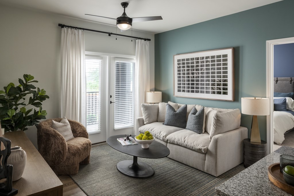 A living room with a couch, chair, and table.