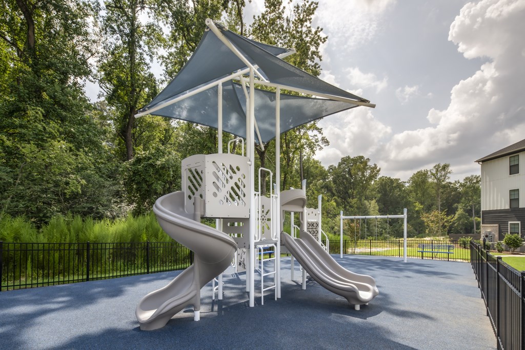 A playground with a slide and a canopy.