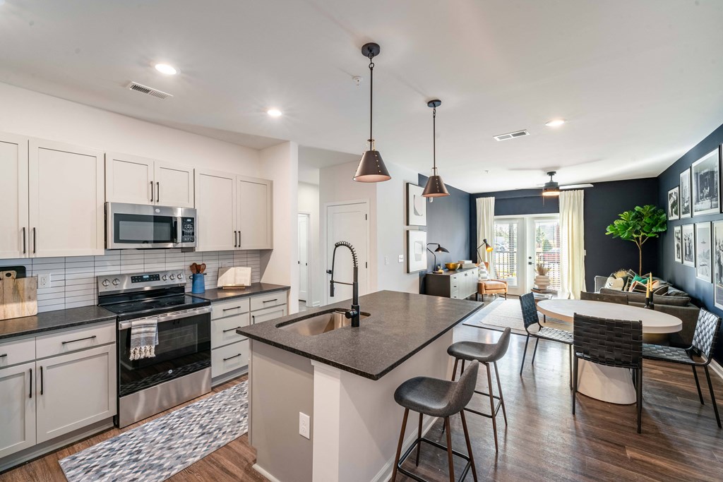 a large kitchen with a center island and a dining table