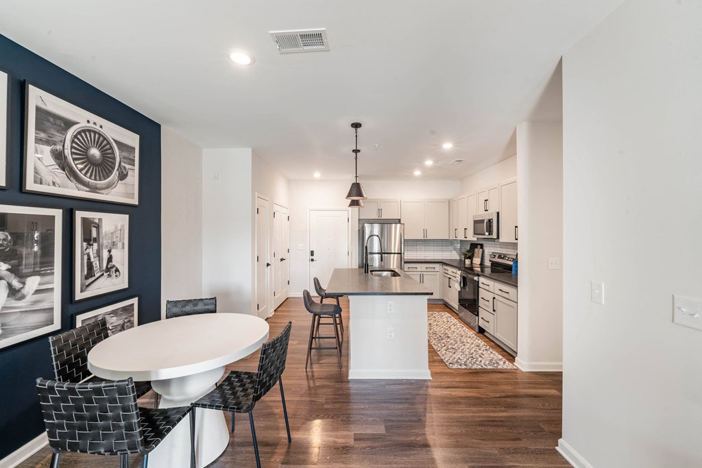 an open kitchen and dining area with a table and chairs