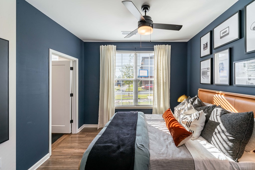 a bedroom with a large bed and a ceiling fan