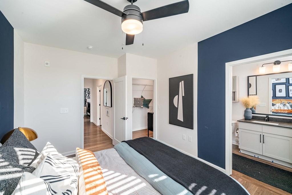 a bedroom with a bed and a ceiling fan