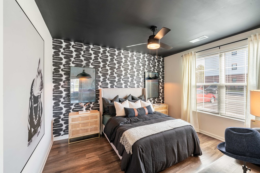 a bedroom with a bed and a patterned accent wall