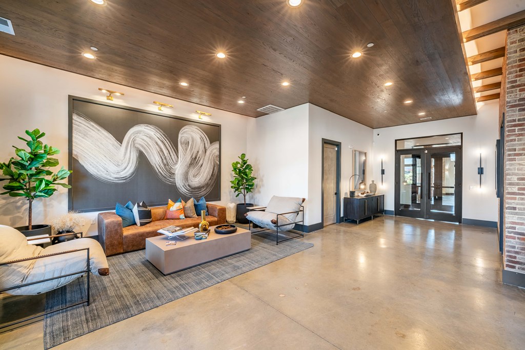 a living room with furniture and a large painting on the wall