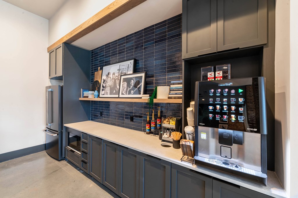 a kitchen with a refrigerator and a coffee machine
